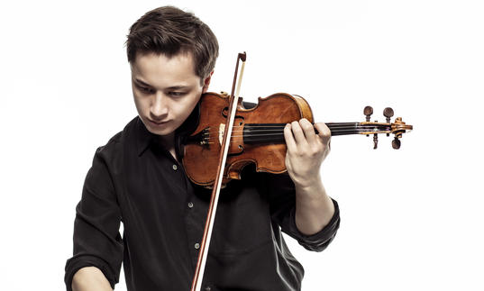 Johan Dalene plays his violin, looking down at the ground