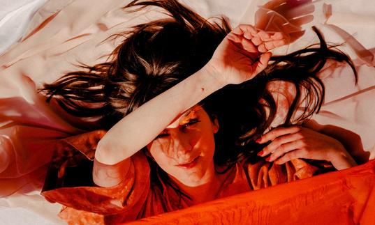 colour photo of Circuit des Yeux wrapped in orange sheets