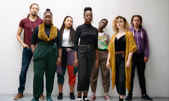 A group photo of Nerija wearing colourful clothes and looking at the camera