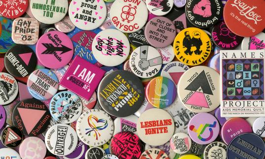 A pile of colourful badges celebrating LGBTQ+ individuals, collectives and organisations.