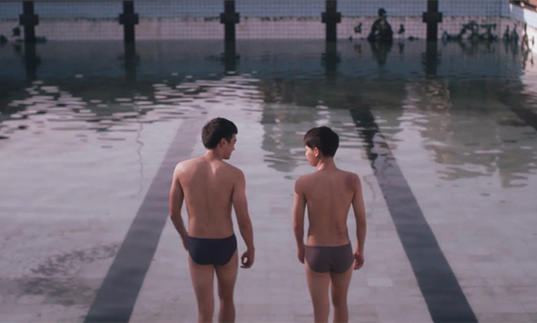 Two men in trucks at the edge of a swimming pool in The Blue Hour