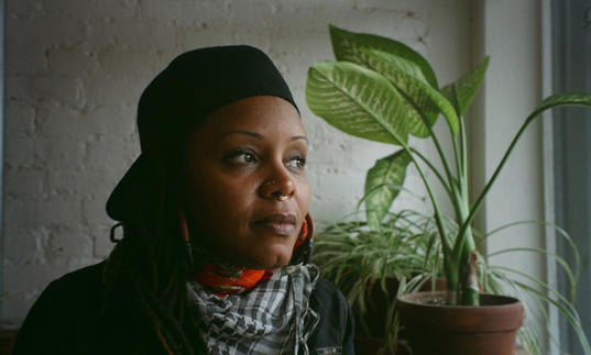 photo of Matana Roberts next to a plant