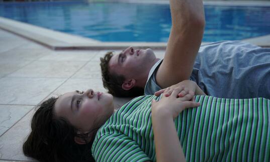 Father and daughter lay on a boat