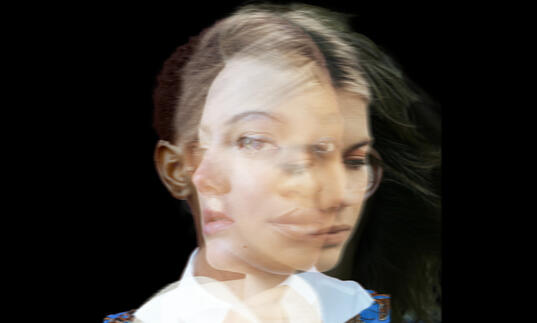 Image of four different woman's faces superimposed on each other, looking in different directions, against a black background