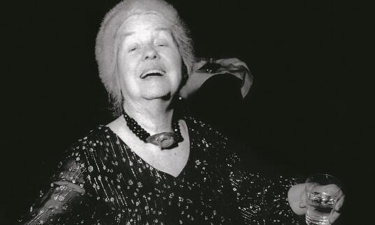 black and white photo of Alice Neel at a party