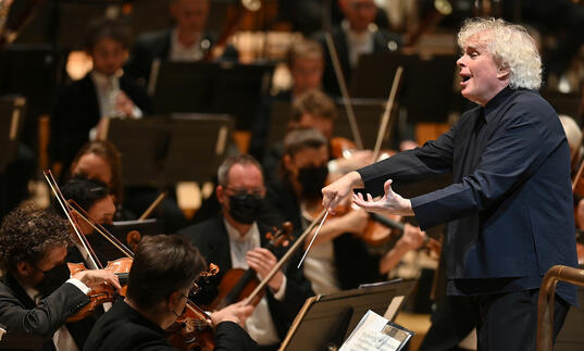 Sir Simon Rattle conducting