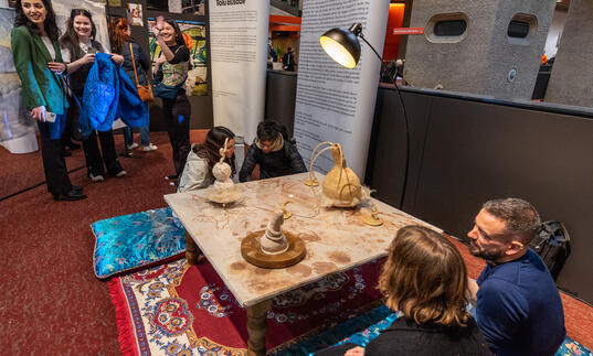 Image of people sat down at an exhibtion