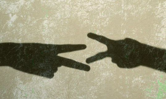 Shadow of two hands forms a still from Francis Alys' Children's Game