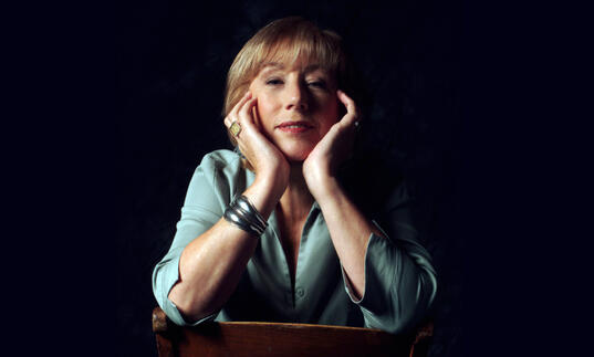 Norma Winstone sitting on chair with hands close to face