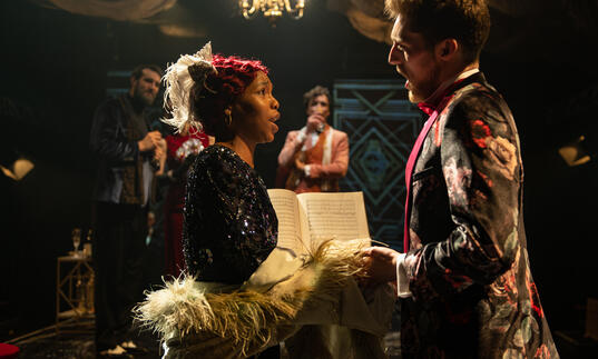 Guildhall School opera singers holding hands facing each other in period 1920s costume