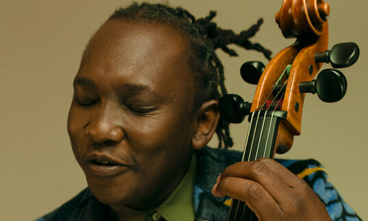 Close up photo of Abel Selaocoe playing his cello