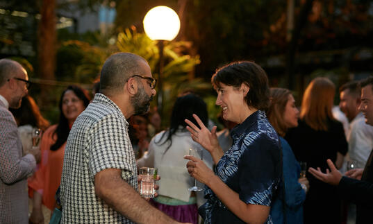  Gathering of guests at a champagne reception in the Barbican Conservatory