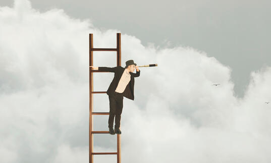 Person dressed in black suit and white shirt at the top of a ladder looking through a telescope, with clouds in the background