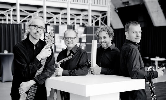 Anouar Brahem Quartet stand with their instruments, smiling to camera