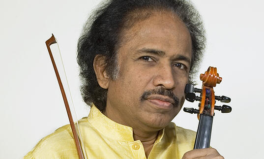 Dr L Subramanium holding a violin
