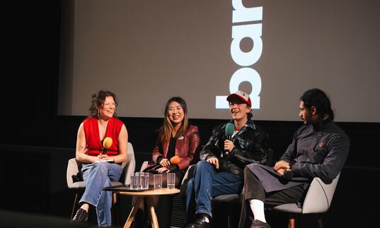 four people sitting at a screentalk panel