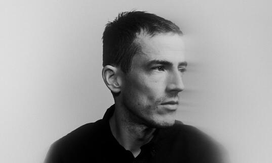 Charlie Cunningham in blurred, black and white image looking to the right pensively