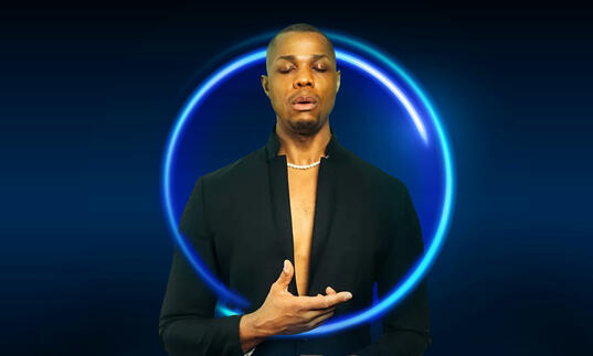 An image of Davóne Tines surrounded by a blue circle against a blue background