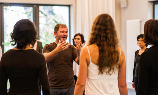 An image of participants in a singing workshop. 