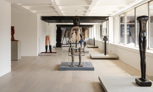 A shot of the gallery, showing sculptures by Giacometti and Huma Bhabha.