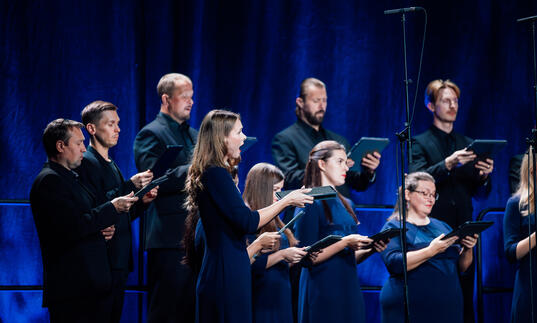 Choir dressed in dark blue singing