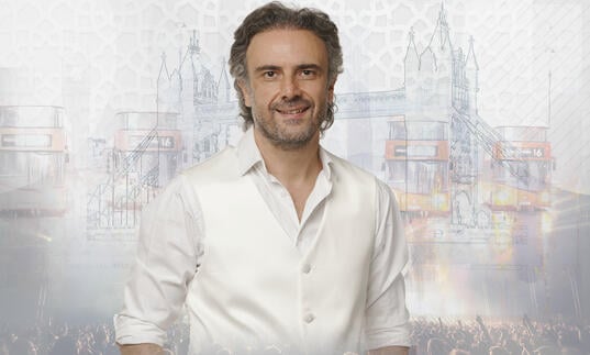 photo of Iyad Rimawi in a white shirt in front of a grey and white background