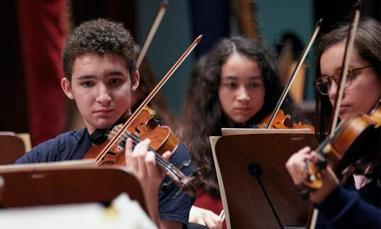 Junior Guildhall Symphony Orchestra violin players