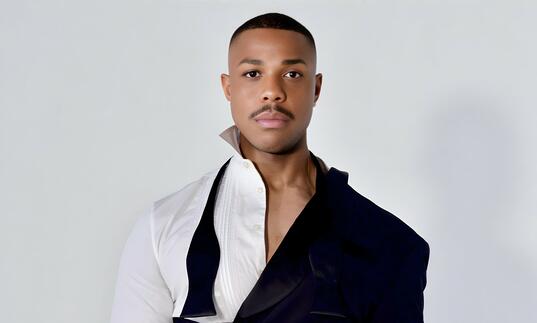 Davone Tines in an avant garde suit