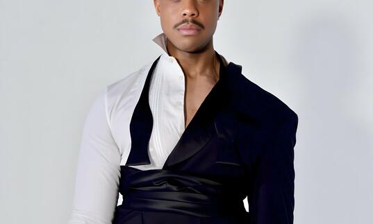 Davone Tines in an avant garde suit