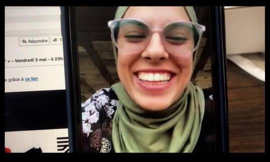 A young woman on a video call.