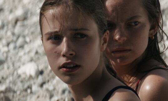 Two young girls looking into the distance.