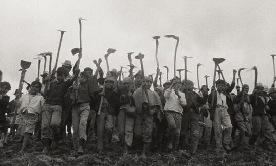 People standing with their tools in hand.