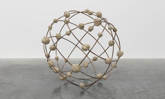 Mona Hatoum's sculpture Orbital - a spherical structure, resembling a globe, made from steel reinforcement bars and clumps of rough concrete 