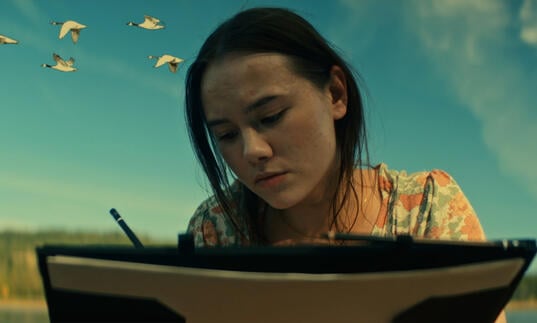 A young woman writing
