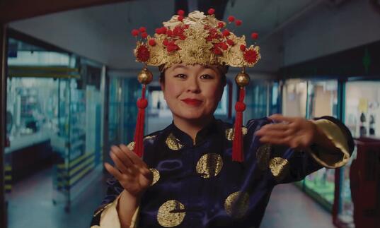 A Vietnamese woman dances in a hallway