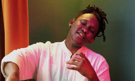 Abel looking wistful playing an air cello 