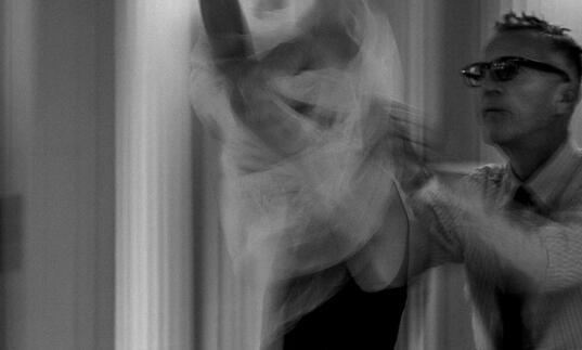 Olivier Sallaird dresses a model in a wedding dr4ess