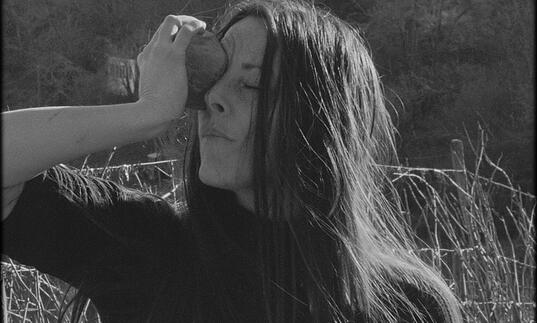 A woman holding something to her face