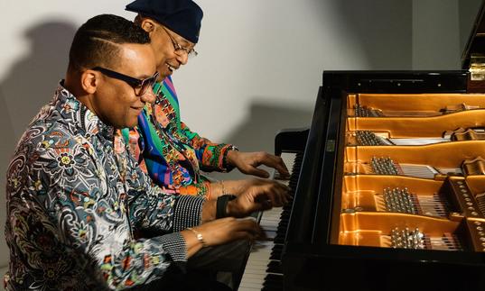 Chucho and Gonzalo playing the piano