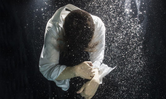 Photo of a figure floating under water