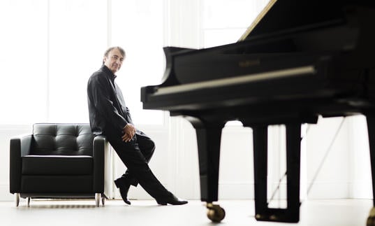 A full colour photograph of Jean-Efflam Bavouzet and piano
