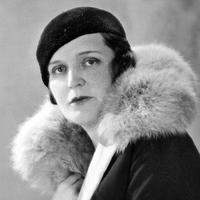 Black and white photo of Germaine Tailleferre wearing a black hat and fur collar