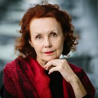 Photo of Kaija Saariaho resting her head on her hand