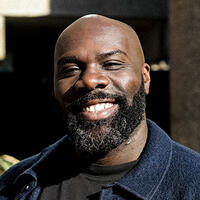 A headshot of Michael &#039;Mikey J&#039; Asante MBE