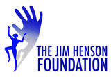 The words &#039;The Jim Henson Foundation&#039; are written in blue writing against a white background. To the left, there is a silhouette of a person dancing whose shadow becomes a large hand.